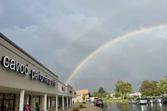 A Rainbow Over th exterior of the Cavod Academy Storefront